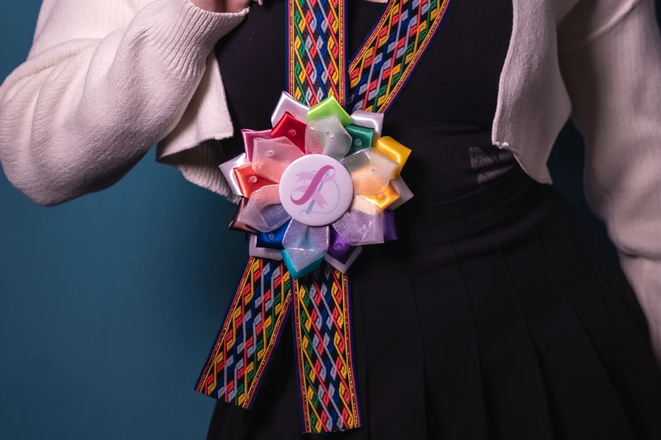 A Guest Wearing a Rainbow Rosette Leis