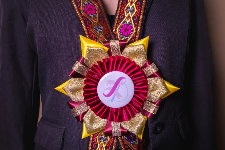 A maroon and yellow rosette leis used in events in the Philippines